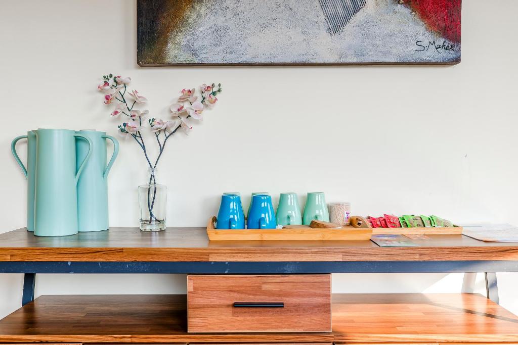 a wooden table with vases on top of it at Southern Sun Homestay North in Kenting