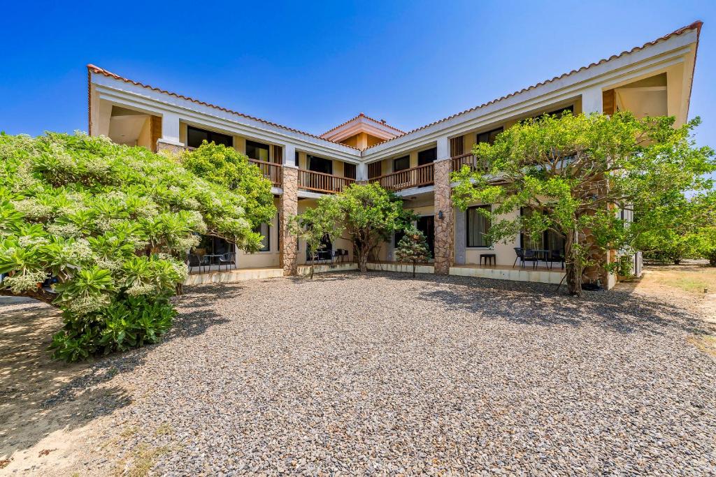 a large house with trees in front of it at Southern Sun Homestay North in Kenting