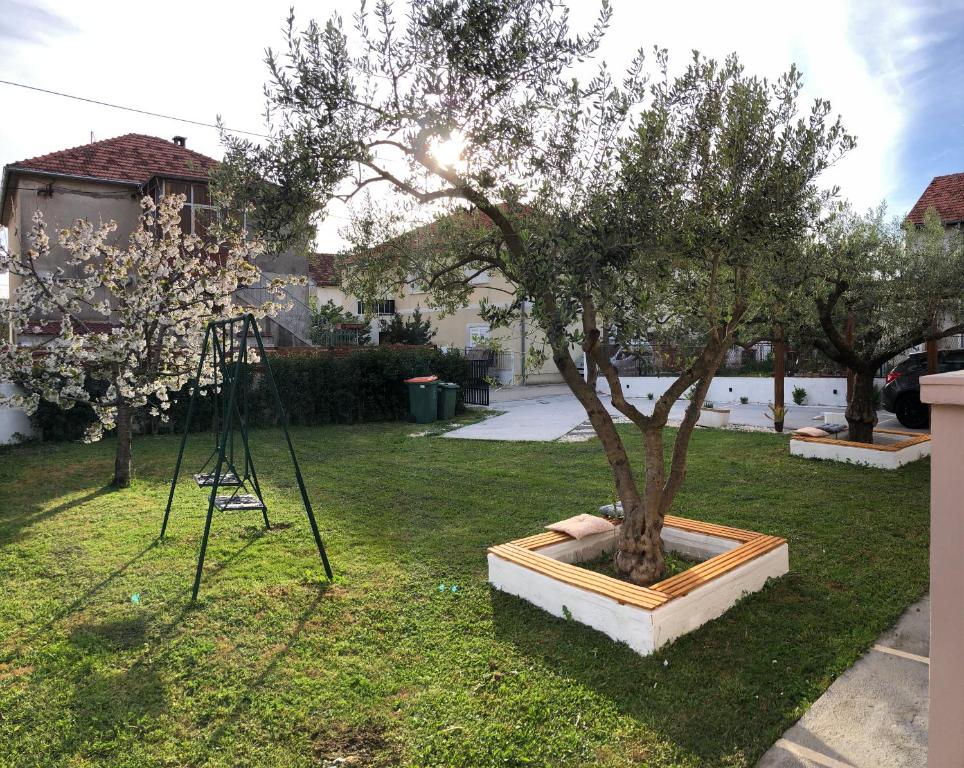 a tree in a pot in a yard at Villa Enthia in Zadar