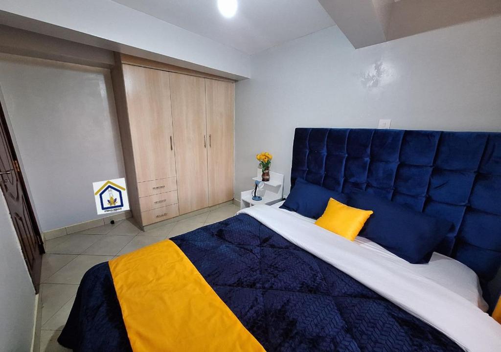 a large blue and yellow bed in a room at Othaya Hideout in Othaya