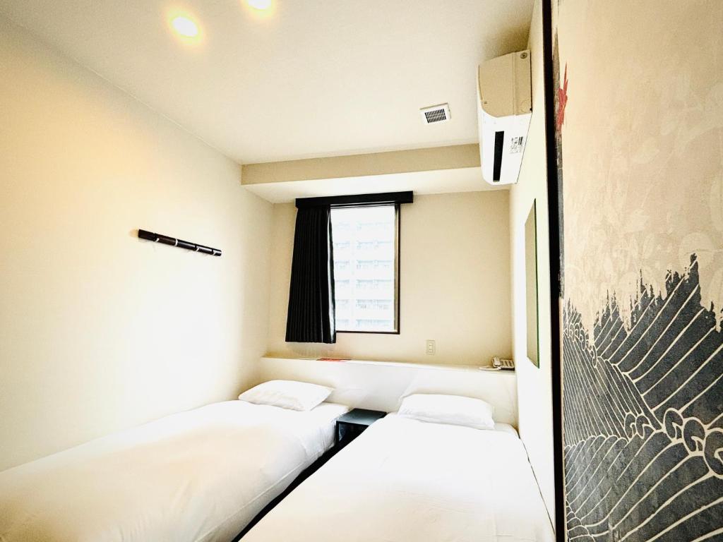 Postel nebo postele na pokoji v ubytování 嵐 Hotel Arashi Namba No102