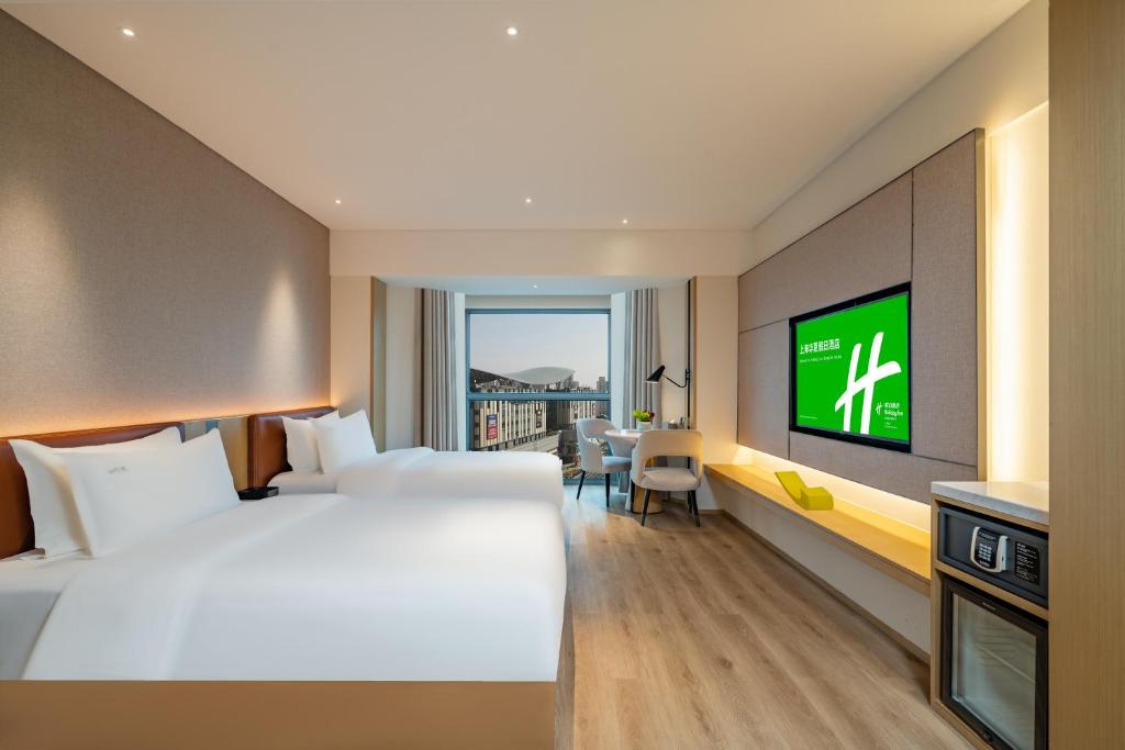 Postel nebo postele na pokoji v ubytování Holiday Inn Shanghai Huaxia by IHG - overlooking city scenery at Sky View Restaurant