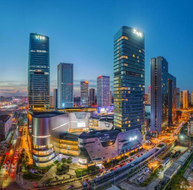 a city skyline with tall skyscrapers at night at Livetour Hotel Panyu Nancun Wanbo Metro Guangzhou in Guangzhou