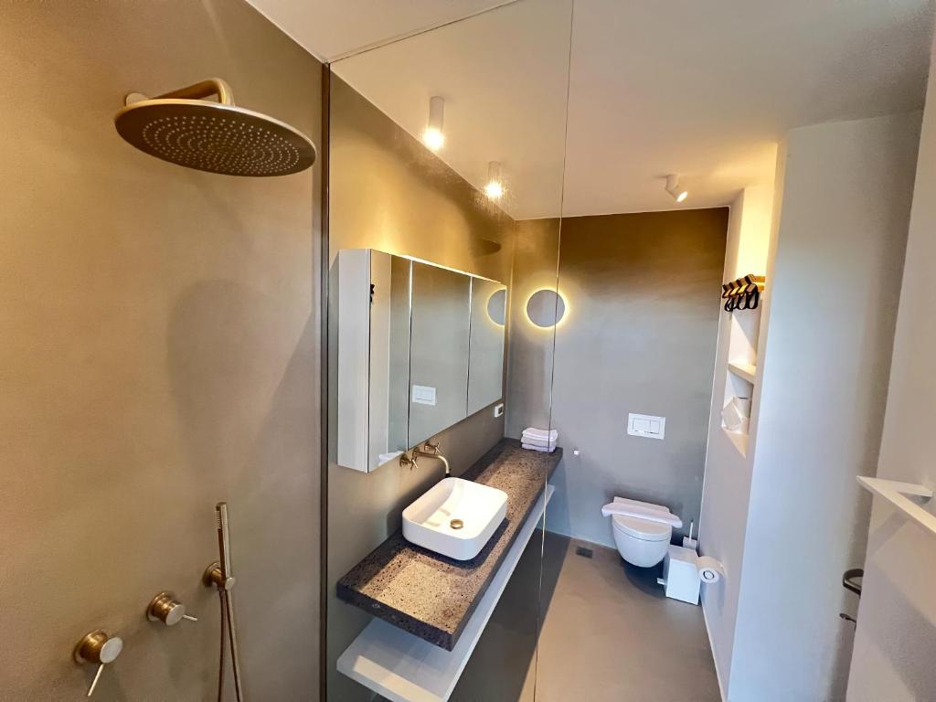 a bathroom with a sink and a toilet at Villa Serene Milos in Empourios