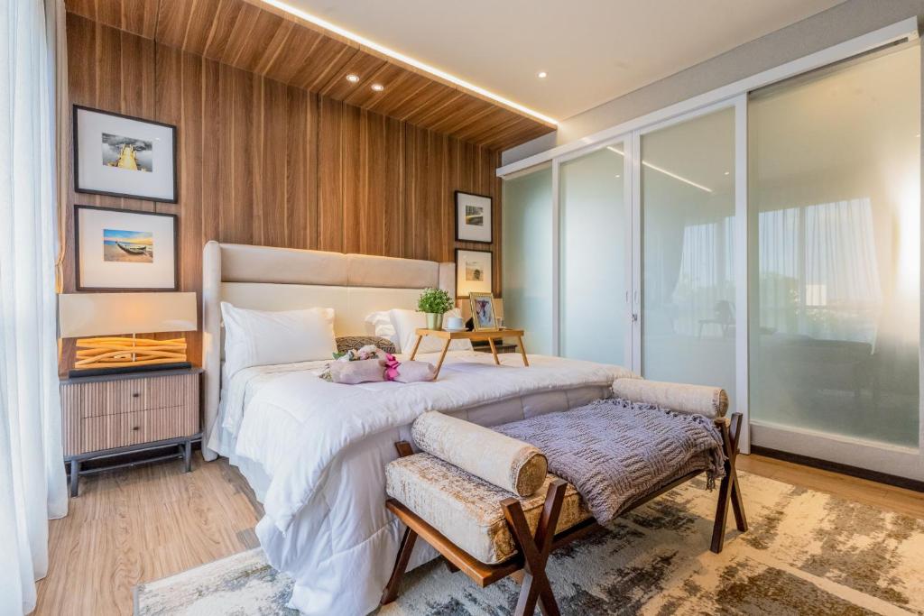 a bedroom with a bed with a teddy bear on it at Alveshouse Suite Bali Villa - Nusa Dua in Ungasan