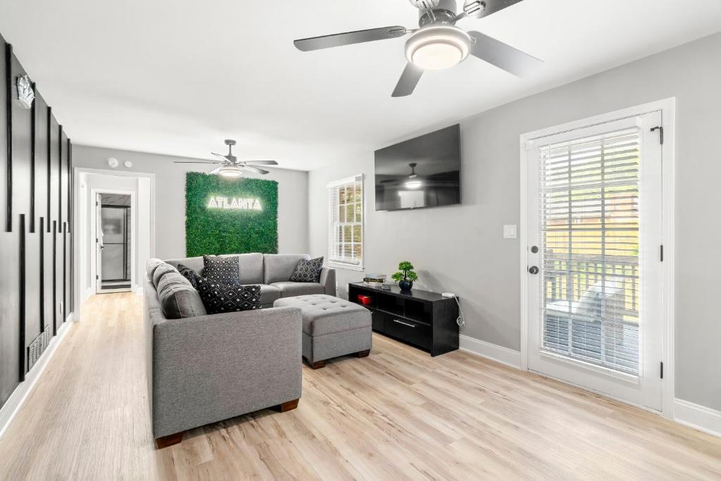 a living room with a couch and a ceiling fan at Opulent Haven Retreats by Deity Villas in Atlanta