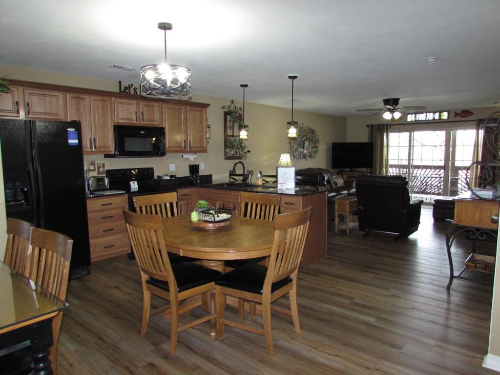 a kitchen and dining room with a table and chairs at Lakefront Condo A-3 in Hollister