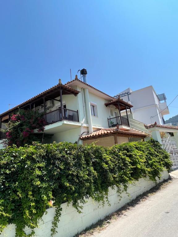 a large house with balconies on top of a hedge at White Dream Apartment in Skopelos Town