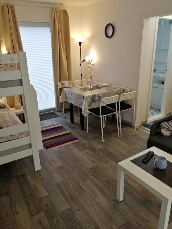 a living room with a table and a bed at FEWO Kliff Watt Nr.4 in Cuxhaven
