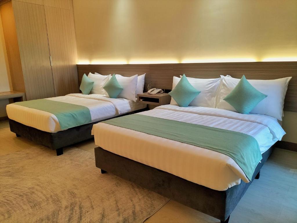 A bed or beds in a room at WATERWORLD HOTEL