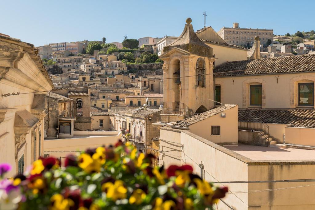 a view of a city with buildings and flowers at La Dolce Vista in Modica