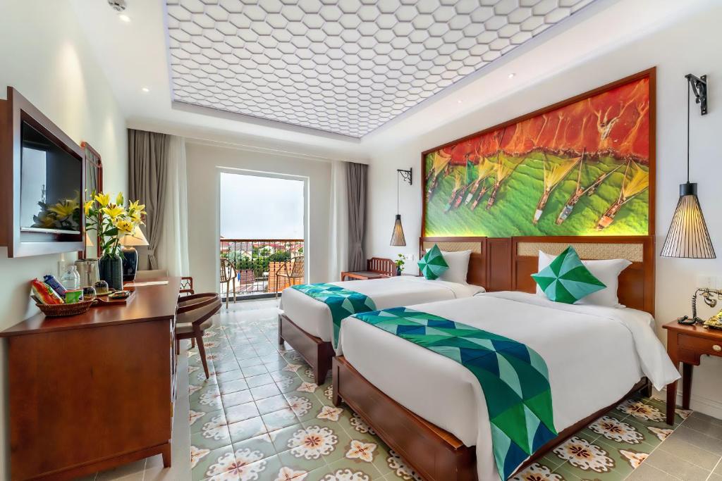 Voodi või voodid majutusasutuse Amina Lantana Hoi An Hotel & Spa toas