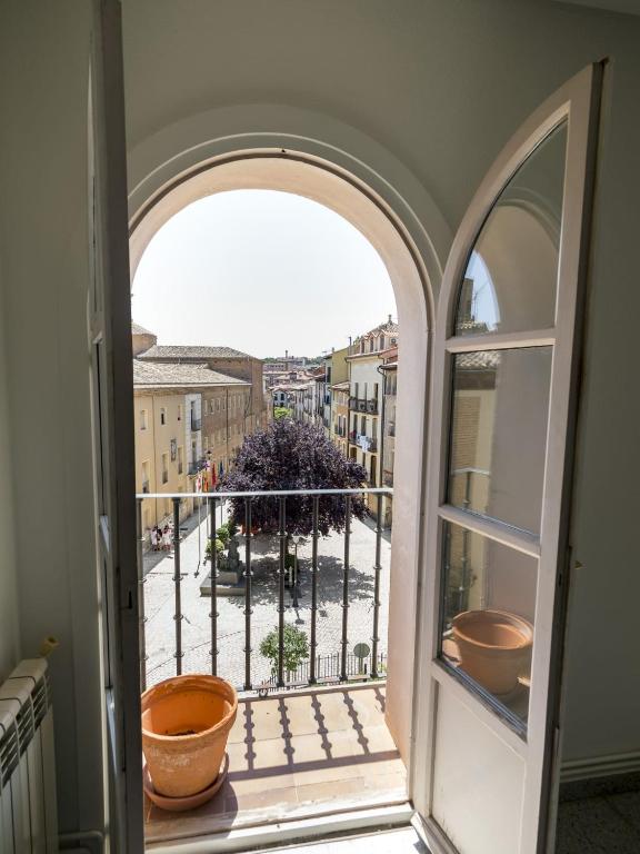 an open window with two pots on a balcony at Plaza Mercadal, Tudela in Tudela