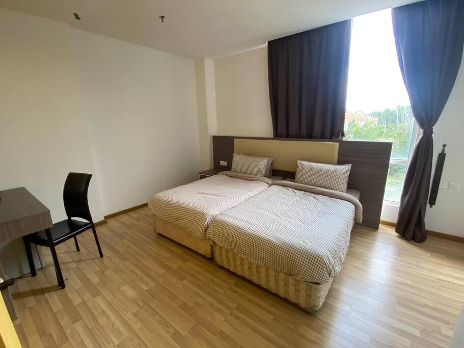 a bedroom with a bed and a desk and a window at Entire Room in Ayer Keroh in Ayer Keroh