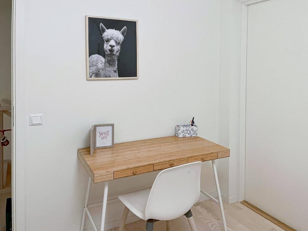 a desk in a room with a picture of a dog at Room in Guest room - Guest room - 5 Min Walk Eurovision Hyllie in Malmö