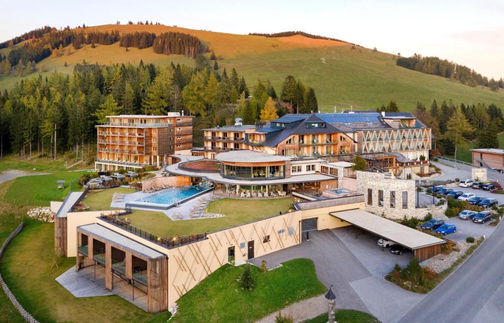 an aerial view of a large building on a hill at Almwellness Hotel Pierer in Fladnitz an der Teichalm