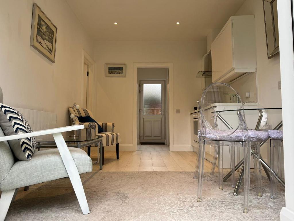 uma sala de estar com uma cadeira e uma mesa em Cosy One Bedroom Apartment Ballsbridge em Dublin