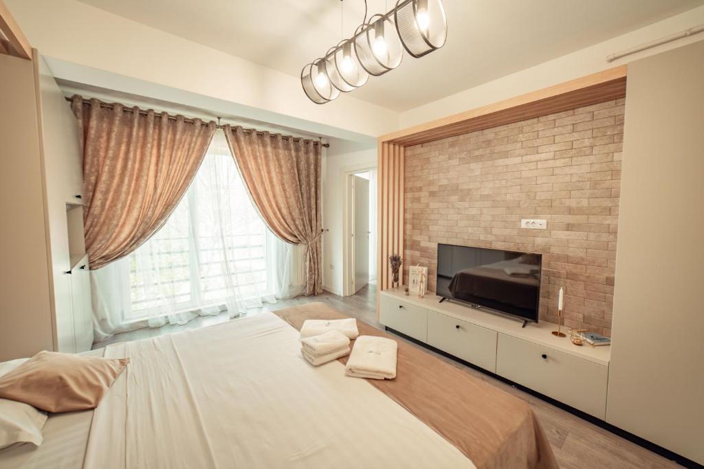 um quarto grande com uma cama grande e uma televisão em Palace of Culture & Palas Mall Collection Suites & Studios em Iaşi