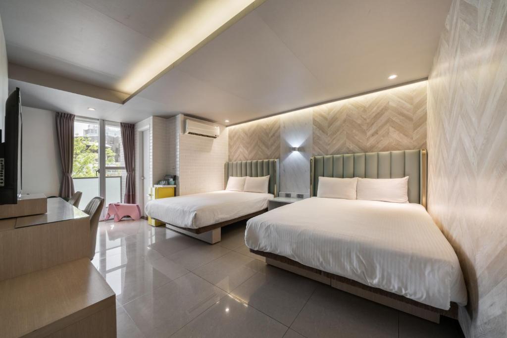Postel nebo postele na pokoji v ubytování S&E Hotel