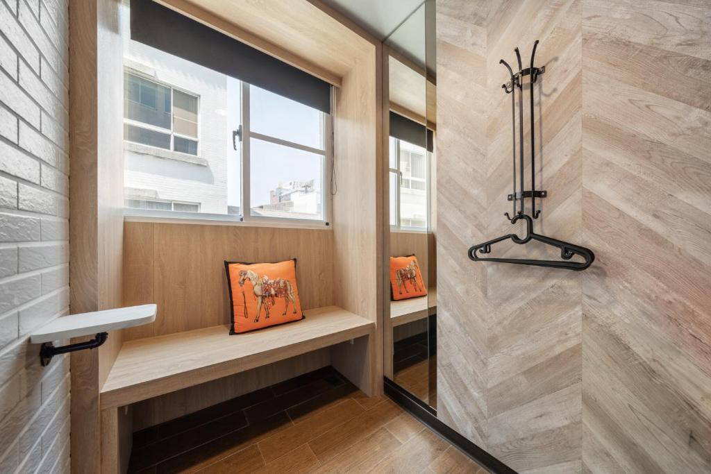 a bathroom with a window and a window seat with a window at S&amp;E Hotel in Tainan