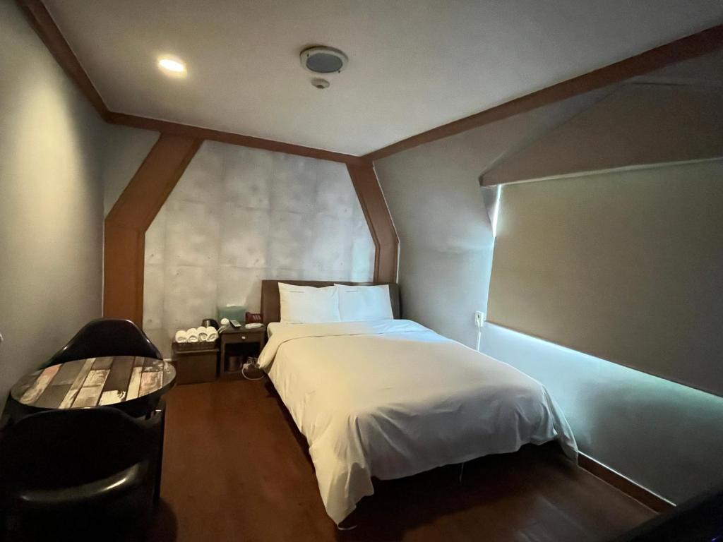 a bedroom with a large white bed in a room at Gooreumseong motel in Seoul