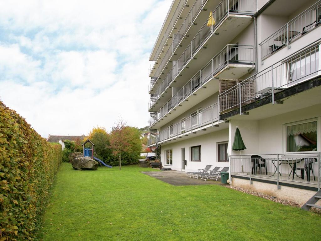 an apartment building with a green lawn in front of it at Apartment with Balcony near the Luxembourg s Border in Bollendorf