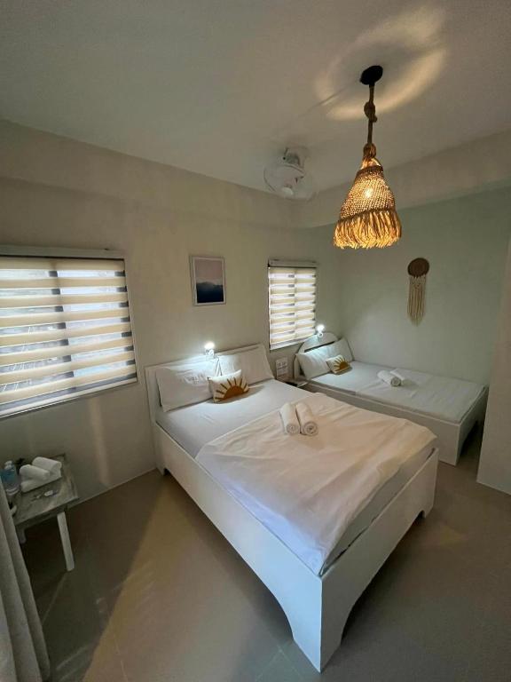 Voodi või voodid majutusasutuse Caleo Boracay Island Station 3 toas