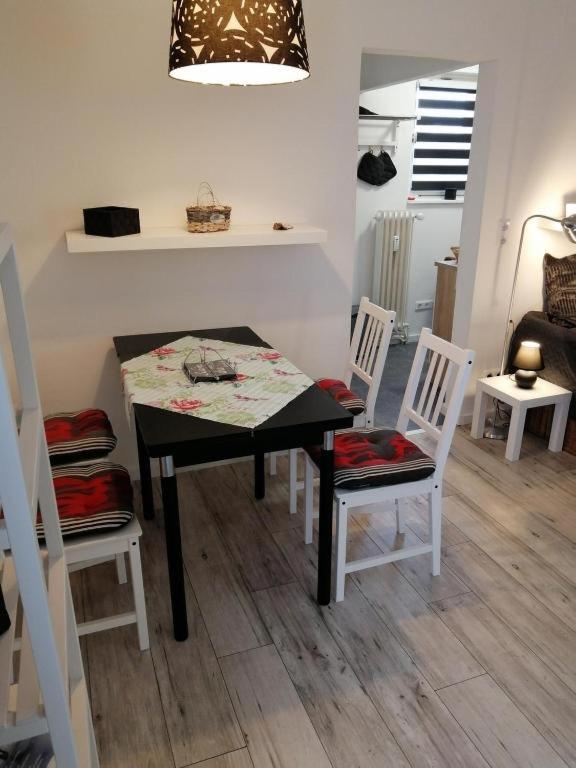 a dining room with a table and four chairs at FEWO Turf Watt Nr.5 in Cuxhaven