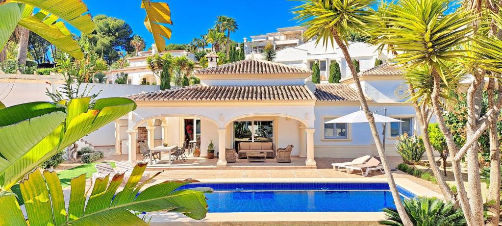 a large white house with a pool in front of it at Villa Sollero by Solidays in Moraira