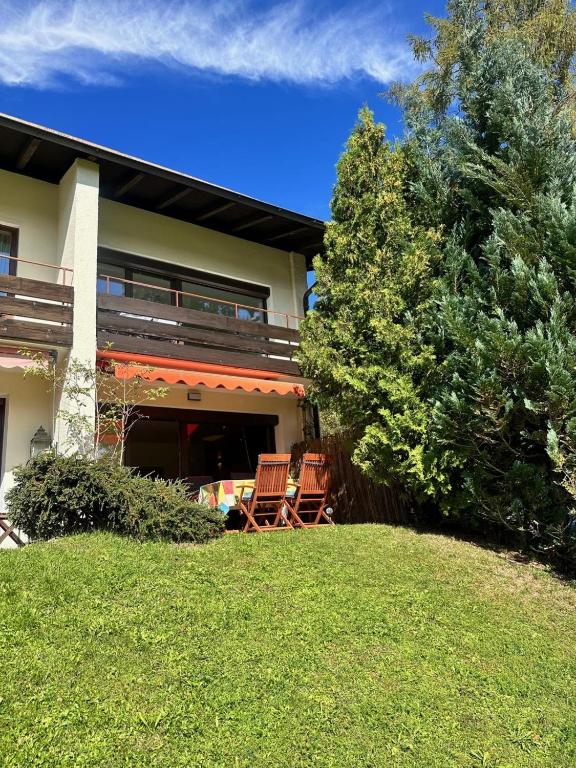two chairs on a lawn in front of a house at Haus MARGOT by MoniCare in Seefeld in Tirol
