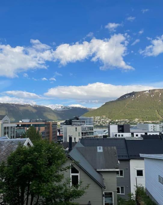 a view of a city with buildings and mountains at Great 2 bedroom apartment in Tromsø centrum! in Tromsø