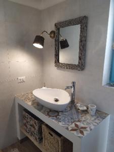 a bathroom with a sink and a mirror on a counter at Antica Storia in Martina Franca