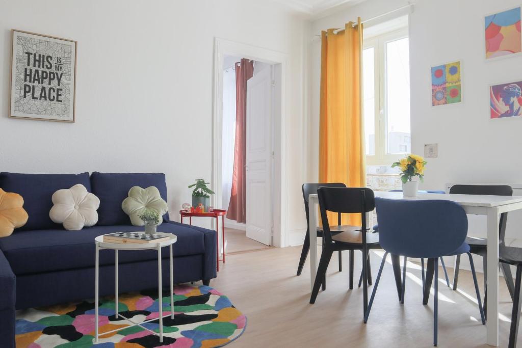 un salon avec un canapé bleu et une table dans l'établissement LE FUNNY, Mulhouse centre, à Mulhouse