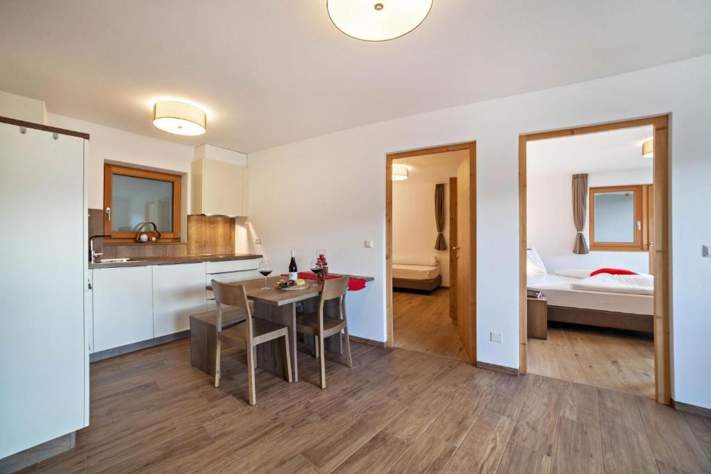 eine Küche und ein Esszimmer mit einem Tisch im Zimmer in der Unterkunft Flatschhof - Apartment Vermoi in Kastelbell