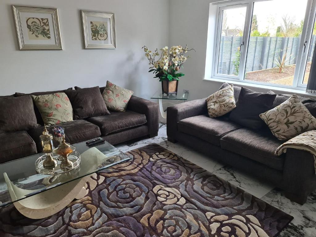 a living room with a couch and a coffee table at SAV 5 Bedroom Executive Detached House in Leicester in Humberstone