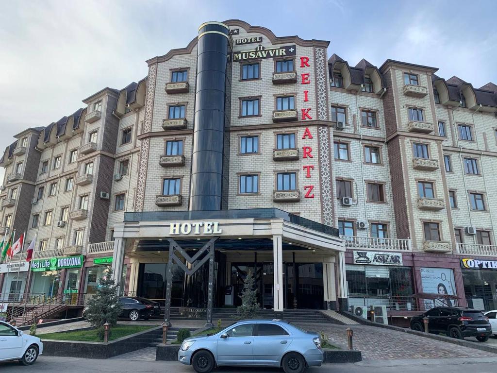 a hotel with a car parked in front of it at Reikartz Namangan in Namangan