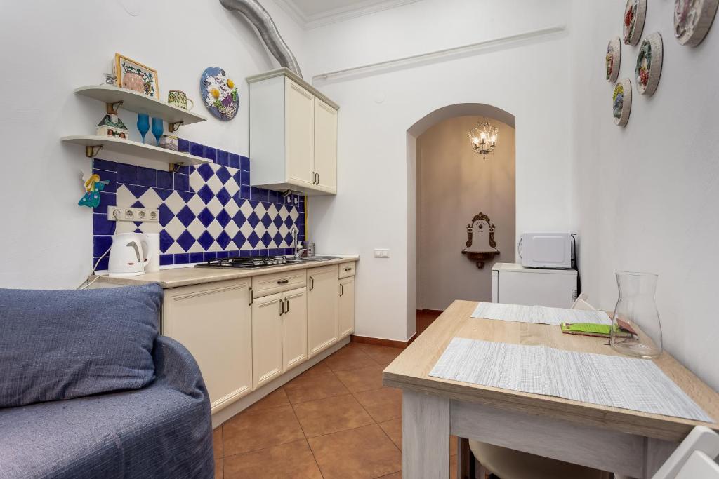 a kitchen with a couch and a table in a room at ART Apartments in Lviv