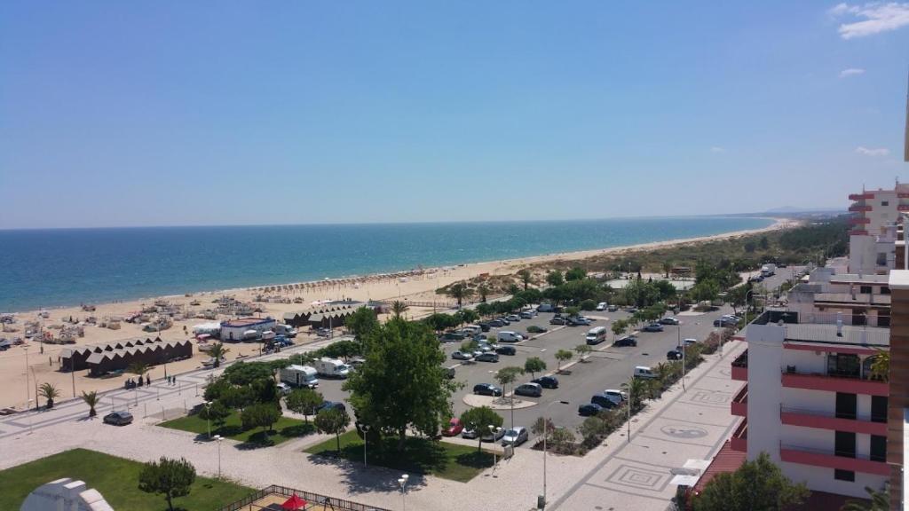 an aerial view of a parking lot next to the beach at Vista Oceânica Paradise in Monte Gordo