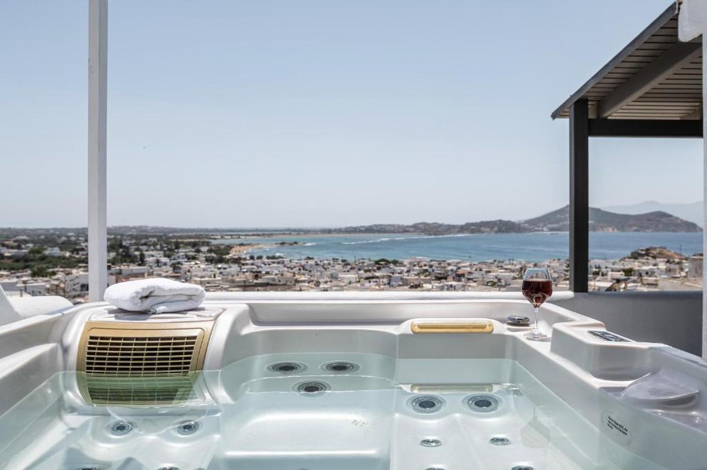 a white bath tub with a glass of wine at K Town Suites Naxos in Naxos Chora