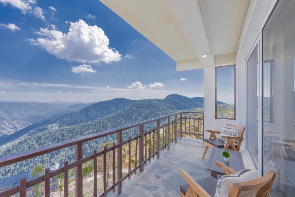 a balcony with a view of the mountains at Hotel Wood Winds - Best Hotel in Chail in Shimla