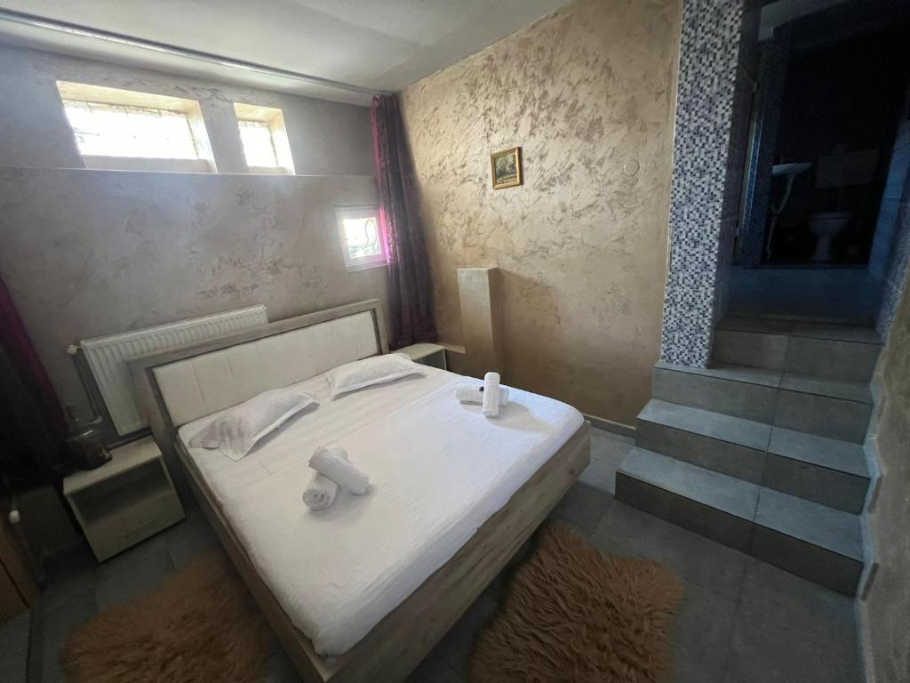 a bedroom with a bed with two towels on it at Pensiunea Pelican in Tulcea