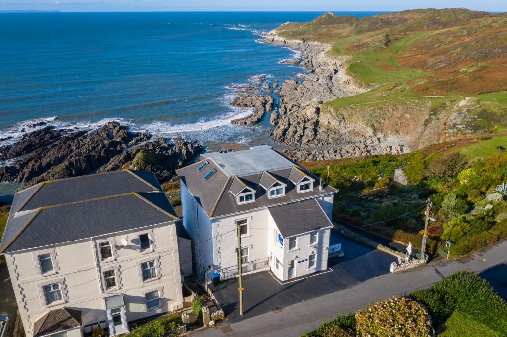 an aerial view of a house and the ocean at Lundy House Hotel in Woolacombe