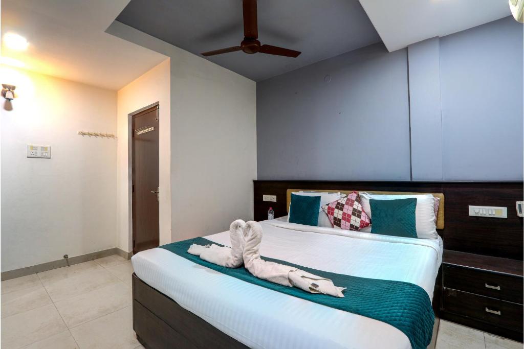 a bedroom with a bed with a towel on it at Fortune pent House Villa in Hyderabad