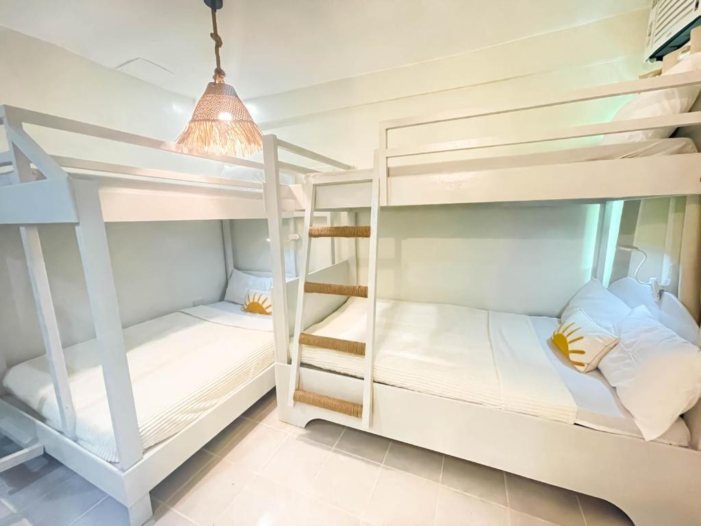 a room with bunk beds in a hostel at Caleo Boracay Island Station 3 in Boracay