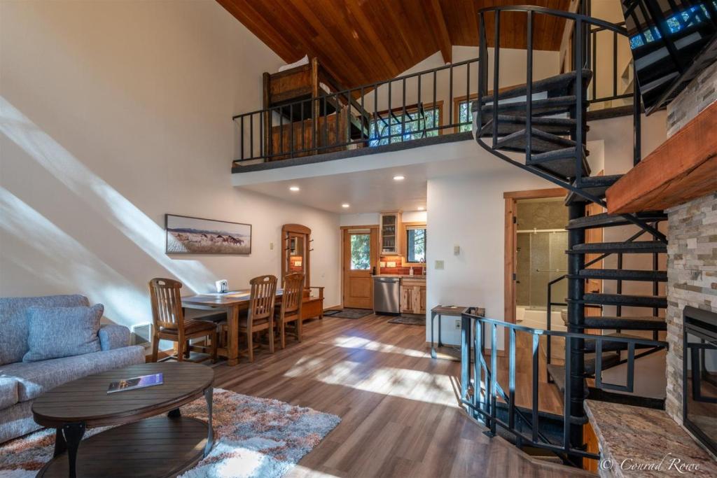a living room with a spiral staircase in a house at 93 Big Prairie in Whitefish