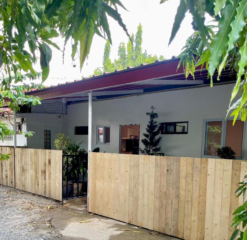 a wooden fence in front of a house at Qali Home in Olongapo