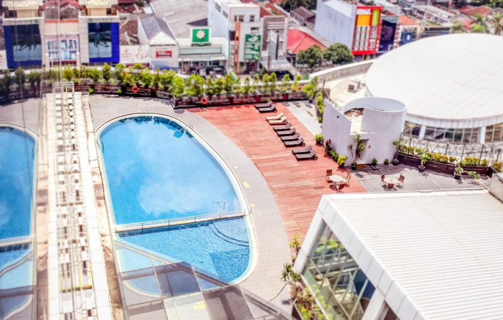 an overhead view of a building with a swimming pool at Swiss-Belhotel Cirebon in Cirebon