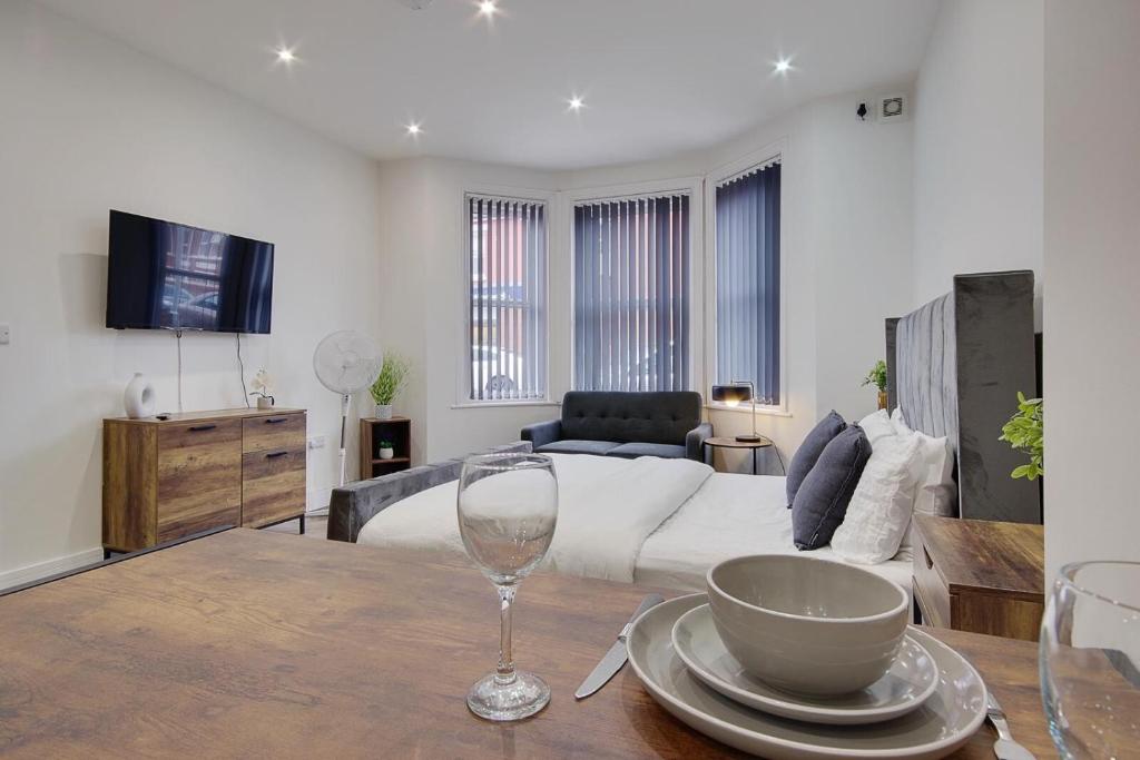 a living room with a wine glass on a table at Ashley Road Apartment 1 in Poole