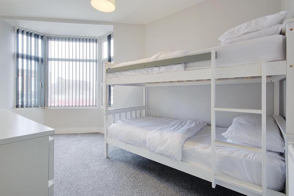 a white bunk bed in a white room at Ashley Road Apartment 2 in Poole