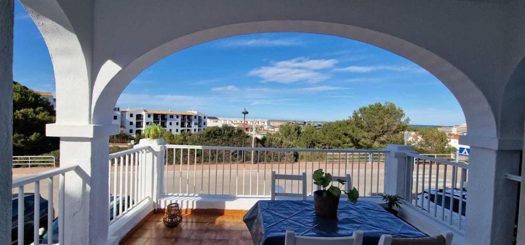a balcony with a table and a view of the city at Apartamento 203 Castell Sol CB in Arenal d'en Castell